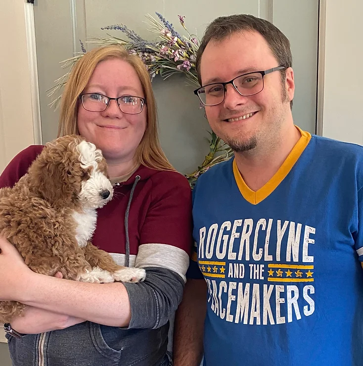 happy customers picking up their red and white puppy from NY Dandy Doodles